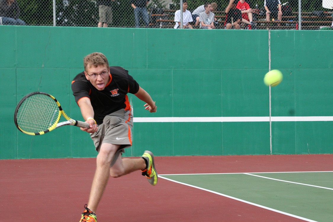 Eyan Cagle glides to the tennis ball for Washougal agaisnt Camas Sept. 10, on the Washougal High School tennis courts.