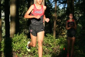 Yacine Guermali builds a commanding lead on runners from Skyview and Columbia River during the final lap along Round Lake at Lacamas Park Sept. 22. The Camas High School junior finished in first place with a time of 17 minutes, 34 seconds.