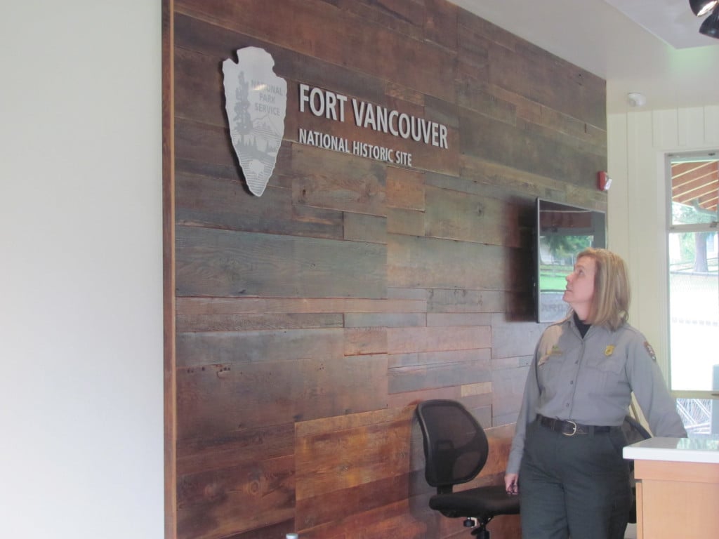 Superintendent Tracy Fortman inspects the new sign in the foyer of the vistor center, which features reclaimed wood from a mill in Oregon.
