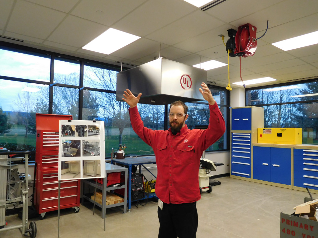 Chris Lodge, lab support employee, explains to visitors the process that occurs in UL's new fabrication lab.