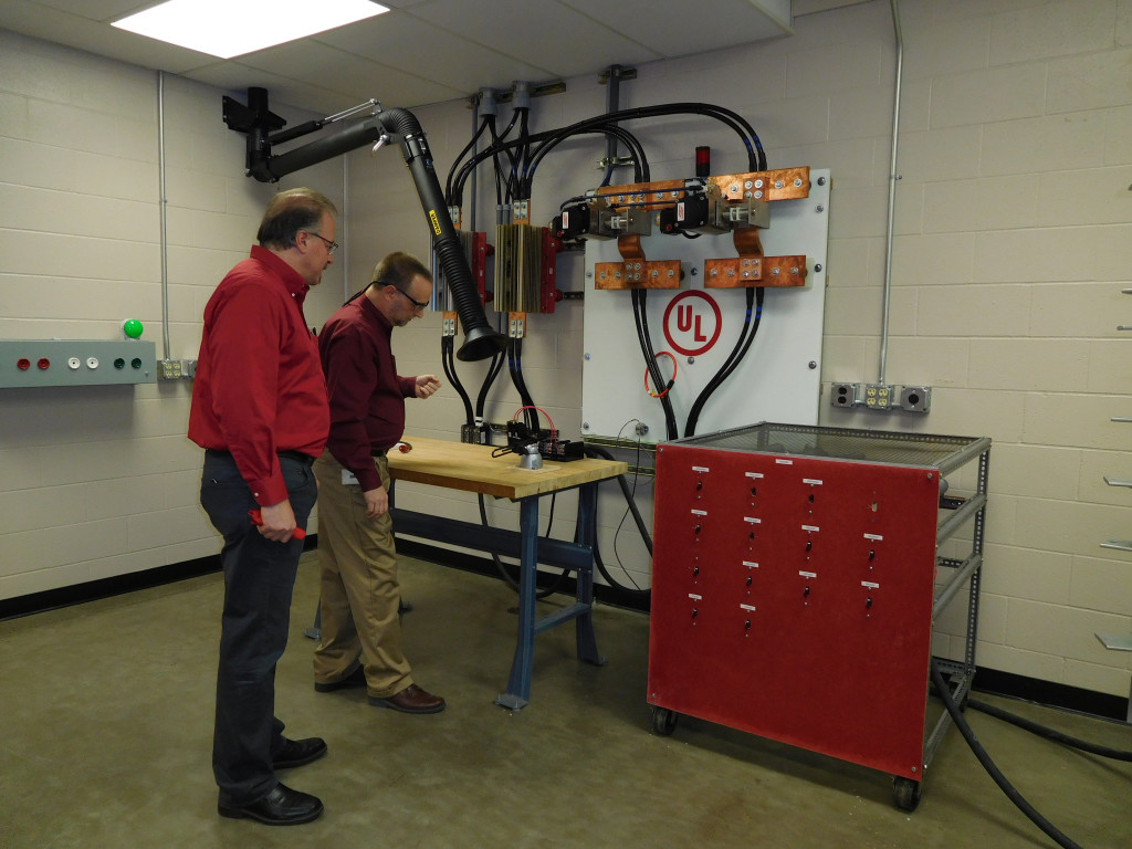 Lemos (left), senior staff engineer, and a lab employee conduct final safety checks before a product test demonstration.