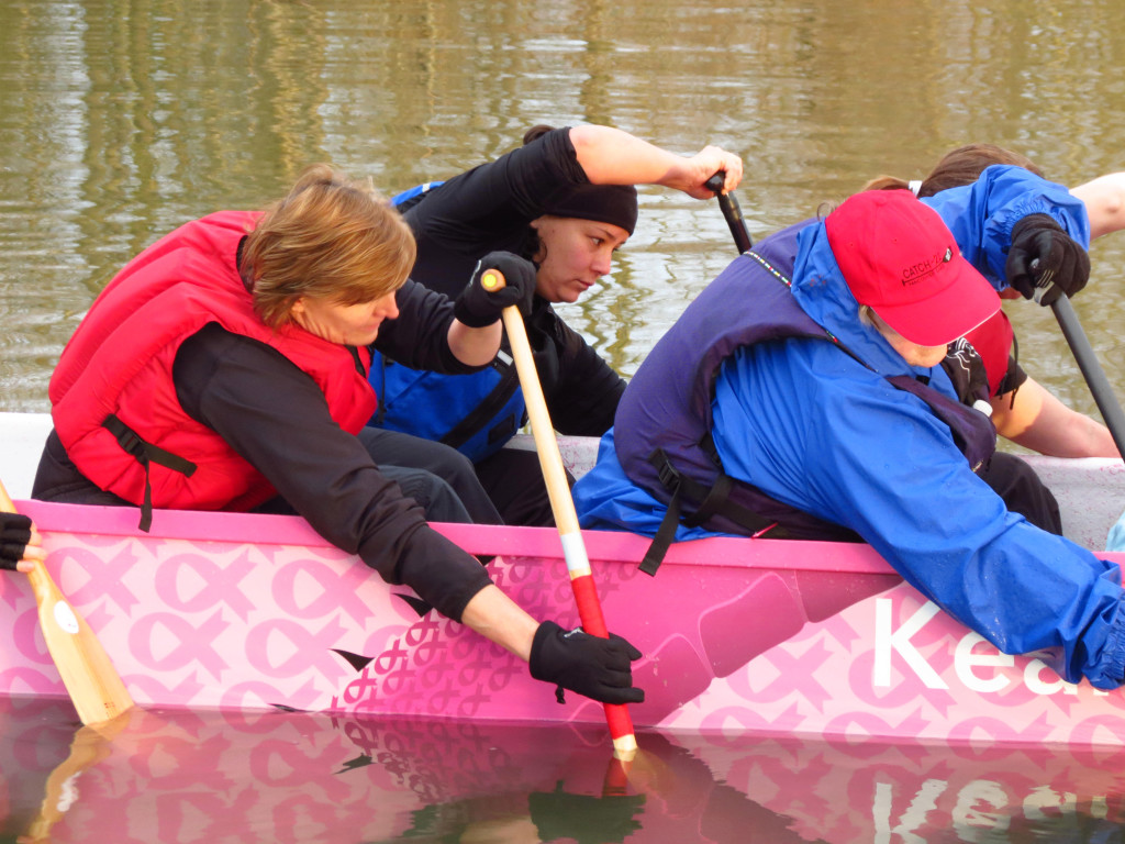 Kit Brown (background) concentrates on being in unison with her teammates. "That unison is what is going to propel the boat forward," she said. "Any type of pitch or hiccup is just going to slow the boat down."