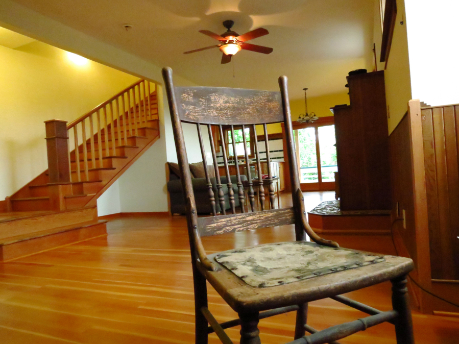 This wood chair was salvaged from a Portland house. Skinner brought it, and several other items he had procured over the years, into his home.