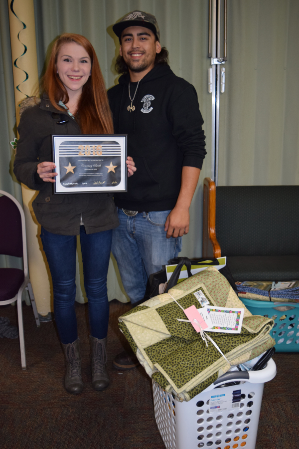 Kids who leave the foster care system often have little beyond their clothing. Here, a young woman poses with her certificate and "graduation basket," filled with toiletries and personal items. (Contributed photo)
