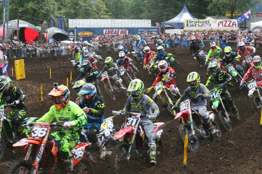 Riders in the 250 class moto 1 made their way around a curve. Some unsuspecting spectators were briefly showered with bits of dirt from the track. Alex Martin led all 16 laps to win the first moto. He placed second in the second moto and claimed the overall victory.