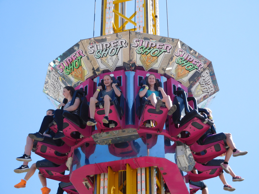The "Super Shot," at the Clark County Fair transports riders high in the air, then drops fast back down. Here, riders anticipate the drop.