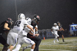 With the Storm on his back, Cooper McNatt carries the football down the field for Camas at Doc Harris Stadium Friday. A 24-0 second half propelled the Papermakers to a 31-9 victory.