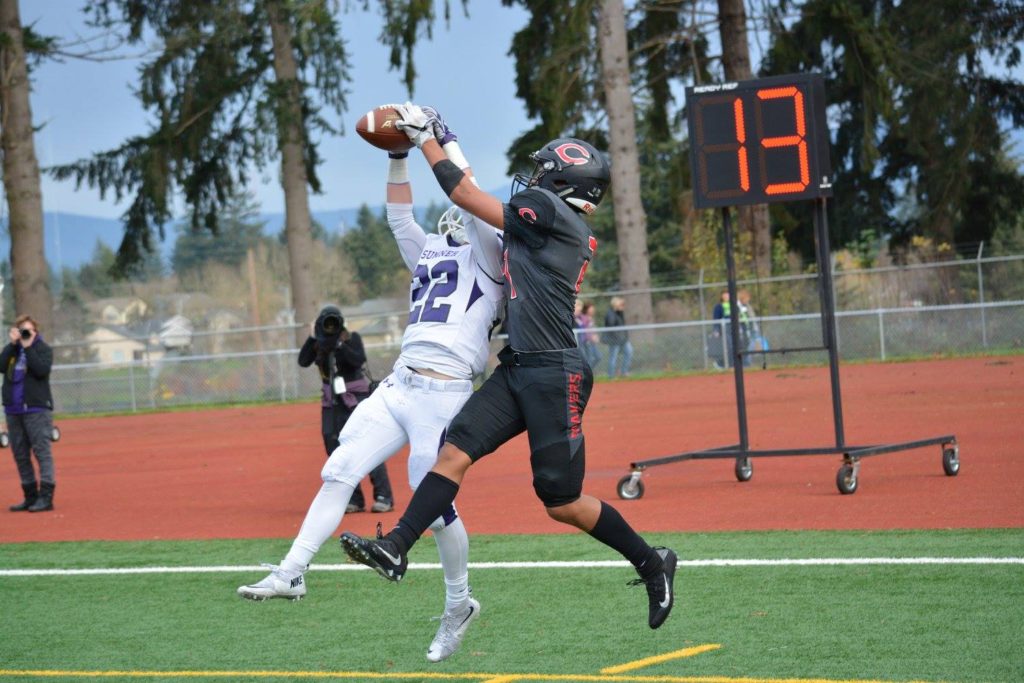 Drake Owen (right) and a Sumner Spartan both get their hands on the football in the end zone, but neither could gain possession.