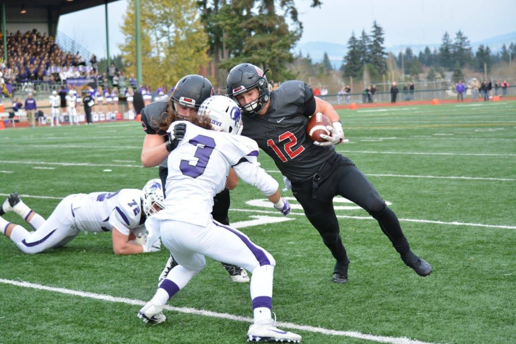 Dakota Napierkowski helps Michael Matthews score one of his three touchdowns for Camas in the semifinals.