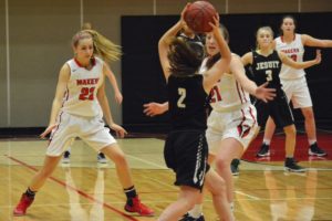 Madison Freemon, Emma Jones and Courtney Clemmer put the squeeze on Jesuit during the fourth quarter Tuesday, at Camas High School. The Papermakers rallied to within two points in the final seconds of the game, but the Crusaders held on for a 34-30 victory.