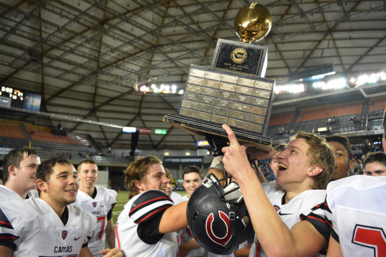 Camas football players hold the state championship trophy up high for everybody to see. The Papermakers defeated the Richland Bombers 24-14 at the Tacoma Dome Saturday, Dec. 3.