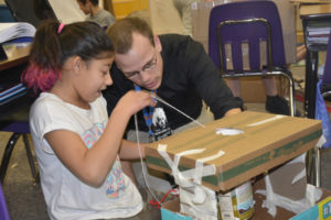 Hathaway fifth-grader Deja'Ray Smith and teacher Andrew Schlauch put the finishing touches on her creation. (Contributed photo)