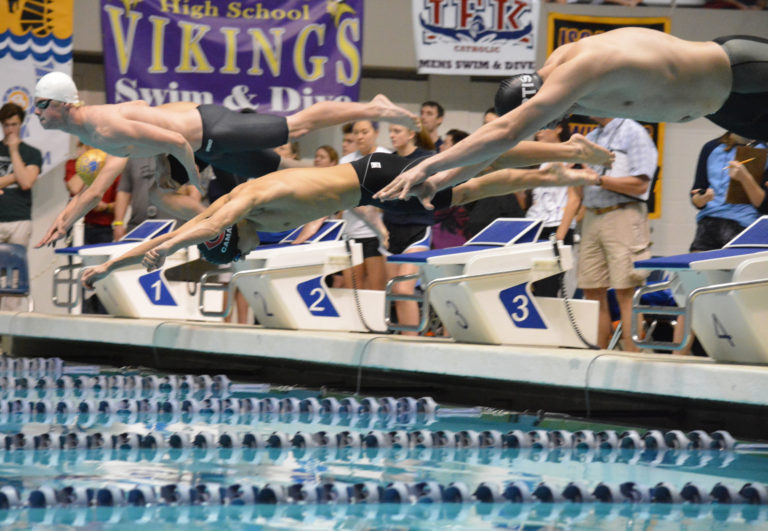 Camas High School senior Tom Utas dives into the pool at the King County Aquatic Center, in Federal Way.