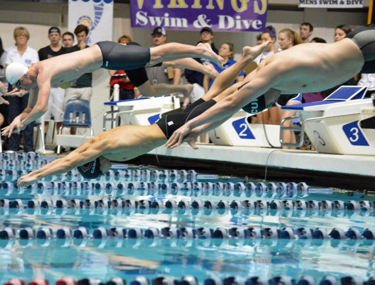 Camas High School senior Tom Utas dives into the pool at the King County Aquatic Center, in Federal Way.