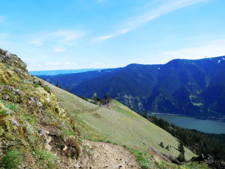 A steep, rocky trail winds down along the side of Dog Mountain.