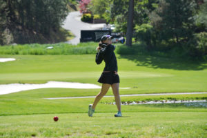 Emma Cox admires one of her longest drives in the state tournament May 26, on the MeadowWood course in Liberty Lake. The CHS sophomore shot a 75 in the first round and a 73 in the finals to tie for third place with a 148. 