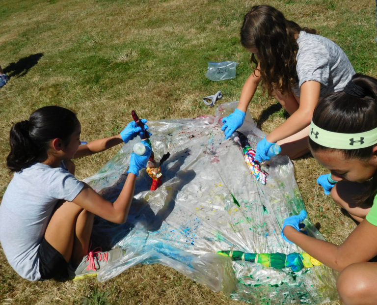 Students design tye-dye shirts during camp. Activities were designed to help them feel pride in themselves and their school.