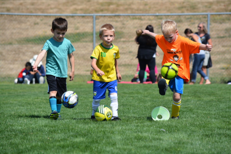 These young boys are getting a kick out of soccer, and gaining new skills with help from the Papermaker girls team that won the Class 4A state title in 2016.