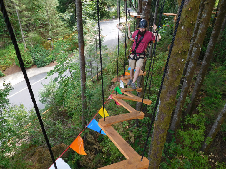 Park Manager Greg Wilkins demonstrates what it&#039;s like to cross one of the more difficult bridges on this aerial obstacle course. It costs $69, plus tax, per person for two hours of activity in the trees.