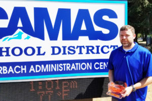 Sherman Davis, Camas School District technology director, was recently honored with a statewide award. He was nominated by one of his employees. Here, Davis holds the award made by art students. "Having great employees makes my job so much easier," he said.