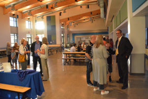 Washougal Schools Superintendent Mark Stromme (far right) greets students and parents in the commons room shared by Columbia River Gorge Elementary and Jemtegaard Middle School. Other Open House guest converse in the background.