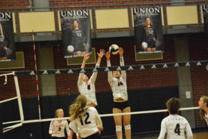 Camas blockers Marianna Payne and Whitney Quist reach up for the volleyball at the net Oct. 19, at Union High School. The Papermakers swept the Titans 25-17, 25-19, 25-22 to remain undefeated in league. 