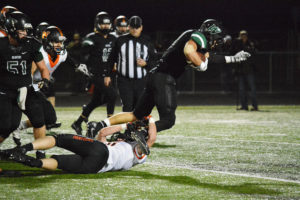 Nathan Tofell tries to stop Woodland running back Tyler Flanagan at Beaver Stadium Friday. Woodland defeated Washougal 20-7.