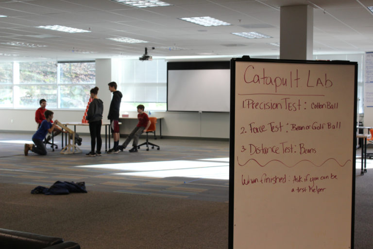 The students at Odyssey Middle School test out the catapults they made as a class project on Friday, Dec.