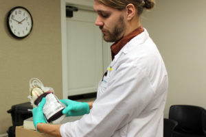 Bloodworks Northwest phlebotomist Jake Cole handles a bag of donated blood. Bloodworks is in need of donors to help replenish its blood supplies after this morning's fatal Amtrak passenger train derailment in DuPont, Washington, betweent Tacoma and Olympia. The blood center is accepting walk-in donors until 4:30 p.m. today, at the Camas Public Library in downtown Camas. 