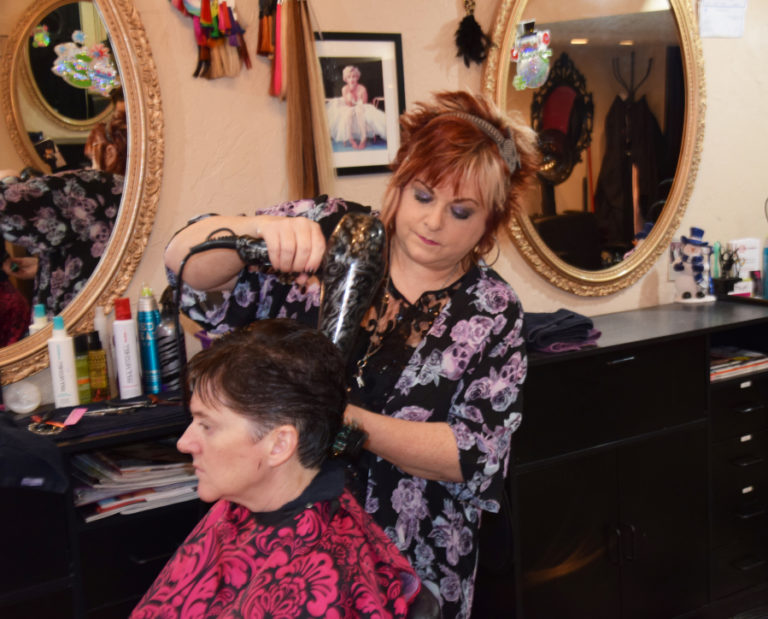 Jyl Straub, owner and stylist at The Wild Hair salon in downtown Camas, finishes client Becky Perman's "just in time for the holidays" haircut on Dec.