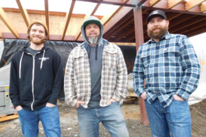 Owen Lamb, Mike Hunsaker and Brendan Greenen (left to right) stand on the future patio area for the Grains of Wrath craft brewery and restaurant in downtown Camas. The three men are brewers, and Hunsaker and Greenen also own Grains of Wrath, along with Shawn Parker and Brendan Ford (not pictured). They plan to open the new business, located at 425 N.E. Birch St., by this spring. 
