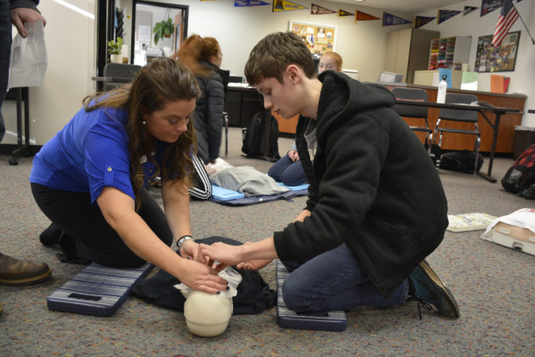 Michelle Kruse of Emergency Response Consultants (left) teaches Washougal High student Josh Veselka life-saving skills during a recent CPR and first aid certification course.