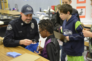 Port of Portland Police Captain and Washougal School District School Board member Cory Chase meets with Gause Elementary School students Jason Meulton, a fifth-grader (left) and Aiden Sled, a third-grader (right) during the school's Jan. 12 Career Day. (Contributed photos by Rene Carroll, courtesy of the Washougal School District)