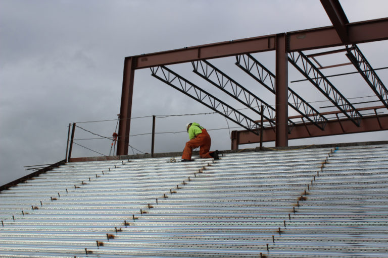 A construction worker helps build  the main staircase inside the future Discovery High on Jan.