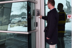 Odyssey Middle School Principal Aaron Smith demonstrates how the video monitoring system at Odyssey Middle School works on Tuesday, Feb. 20. All of the schools in the Camas School District, except Camas High, have a video and buzzer entry system. 