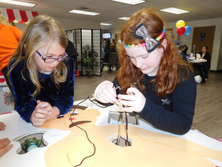 Eden Hall, 7, of Washougal (right) plays &quot;Operation&quot; Saturday in the new Salvation Army community center.