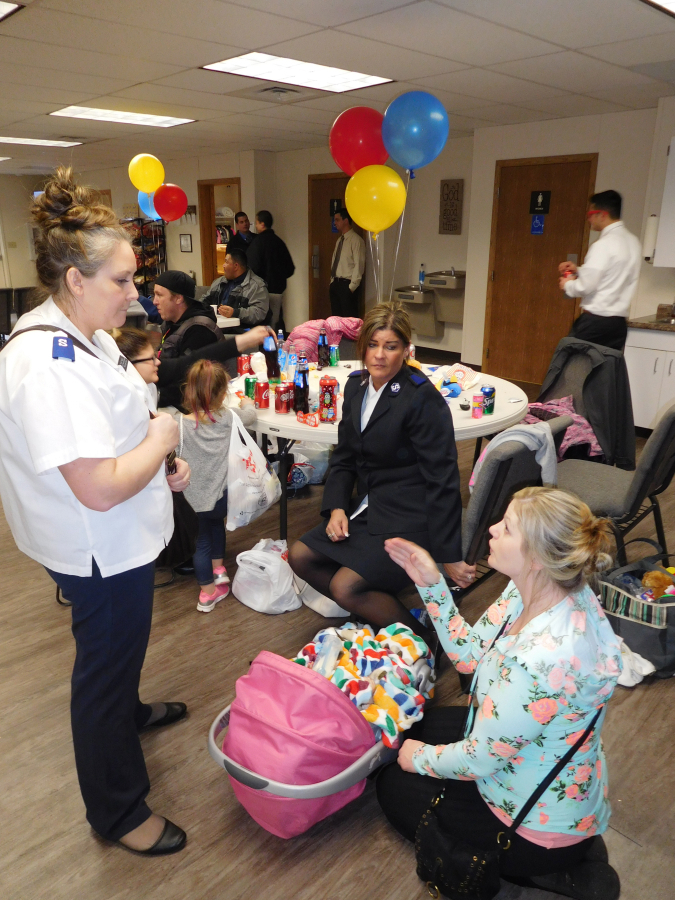 Kendra Taggart, social service coordinator for the Salvation Army of Camas/Washougal (left), talks with local residents who attended an open house Saturday, Feb. 24, at the ministry and social services provider&#039;s new community center in Washougal. The NW Brass &amp; Chorus performed during a building dedication service Saturday evening and a 20-year anniversary celebration service Sunday morning.