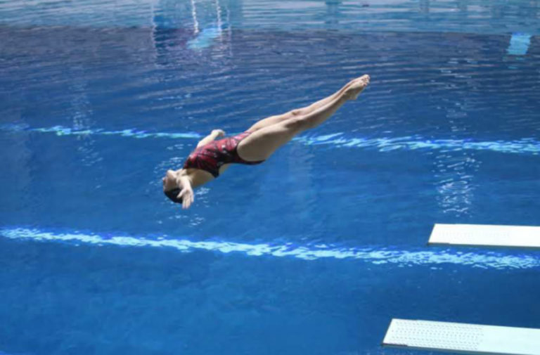 Jax Purwins performs on the 1-meter board during a 2017 meet.
