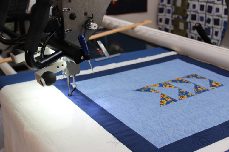 Camas quilter DeAnn Perrigo's 14-foot-long long-arm quilting machine quilts Perrigo's "Flying Geese" quilt. The quilt will be one of two Perrigo enters in the upcoming Clark County Quilters' 43rd annual Quilt Show, which begins at 10 a.m., Thursday, April 5 and runs through Saturday, April 7, at the Clark County Event Center in Ridgefield.