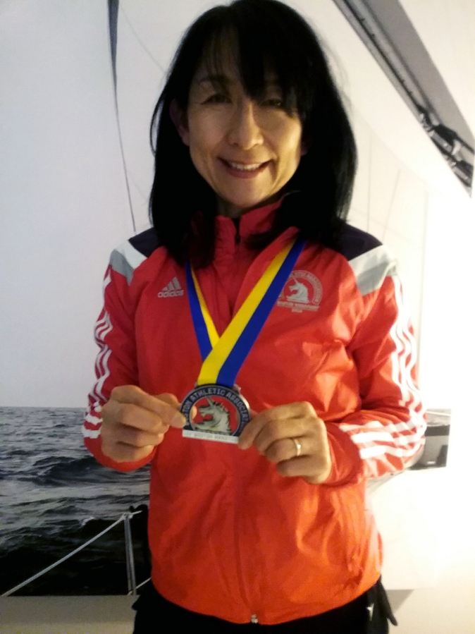 Satomi Sano-Abrahamsen, of Camas, shows off her medal after finishing the prestigious Boston Marathon on Monday, April 16. (Contributed photo courtesy of Gary Abrahamsen)
