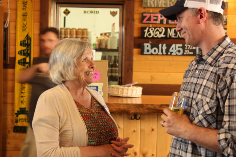 Washougal City Councilwoman and Mayor Pro Tem Joyce Lindsay (left) talks to 54?40' Brewing Company owner Bolt Minister at a May 9 fundraiser for congressional candidate Carolyn Long, a Democrat vying for Republican Rep.