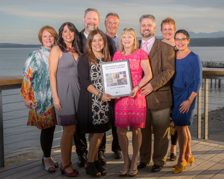 Representatives of the Downtown Camas Association and Salud! Wine Bar celebrate Salud! receiving an economic vitality award during the Washington State Main Street Program&#039;s Excellence on Main ceremony, April 24, in Port Townsend, Washington. Jan Carter, Dawn White, Yolanda Taylor and Raechill Dotson (front row, from left to right) and Gerald Taylor, Randy Curtis, Tony Dotson, Carrie Schulstad and Carolyn Mercury (back row, from left to right) are pictured.