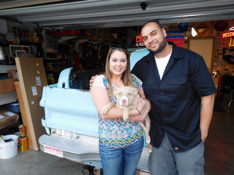 Jon Corral, his wife, Alyssa, and their dog, Louie, enjoy a springtime evening in front of their Washougal home. Jon, a 2004 Camas High School graduate, builds cars inside his two-car garage.