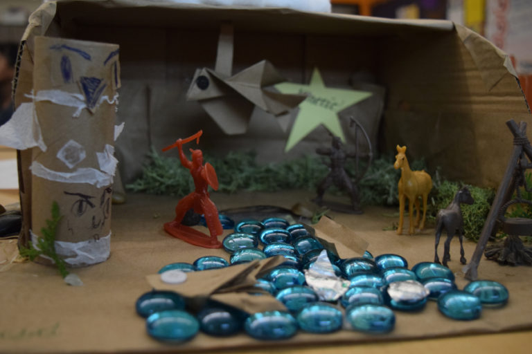 Third-grader Valerie Salcedo created this plank house, using blue beads to represent the river where Northwest Coast Native Americans caught salmon.