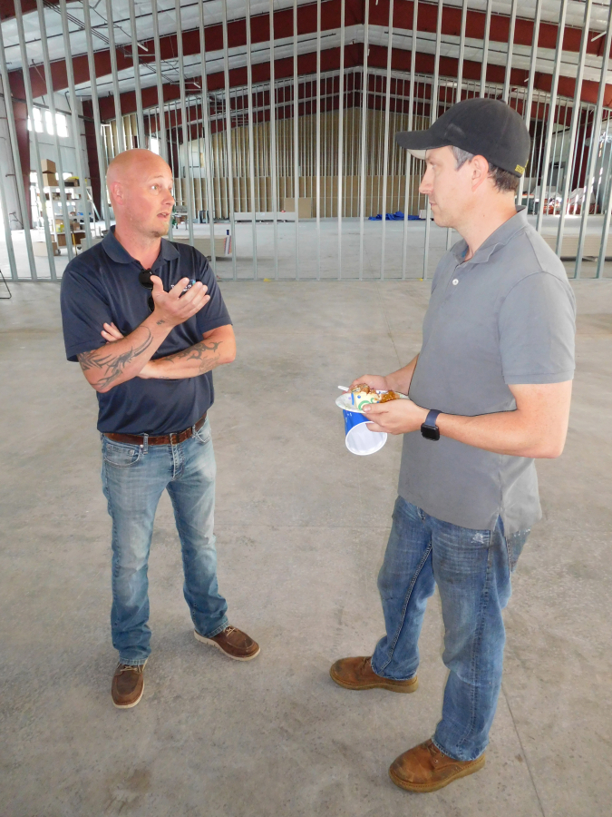 Port of Camas-Washougal Facilities Manager Jeramy Wilcox (left) talks with Josh Swift (right), owner of Swift Machining, during an open house in Building 18, May 23. Six companies, with a starting workforce of 85 to 90 employees, will locate in the 49,500 square foot building -- the Port&#039;s largest structure to date -- in the Steigerwald Commerce Center.