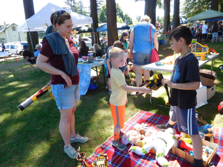 Young entrepreneurs sell toys, games and homemade arts and crafts, at the Camtown Youth Festival children's flea market, on Saturday, June 2.