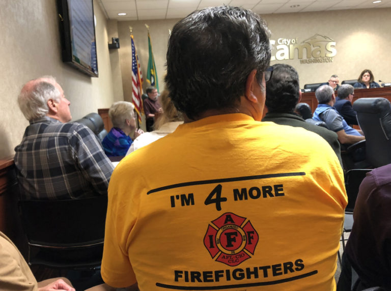 Camas-Washougal Fire Department Battalion Chief Larry Larimer wears a yellow "I'm 4 More Firefighters" T-shirt to a June 4 Camas City Council meeting, where he and several other firefighters spoke about a recent state report that found the city of Camas in violation of breaking firefighter safety laws and urged higher staffing levels at the local fire department.