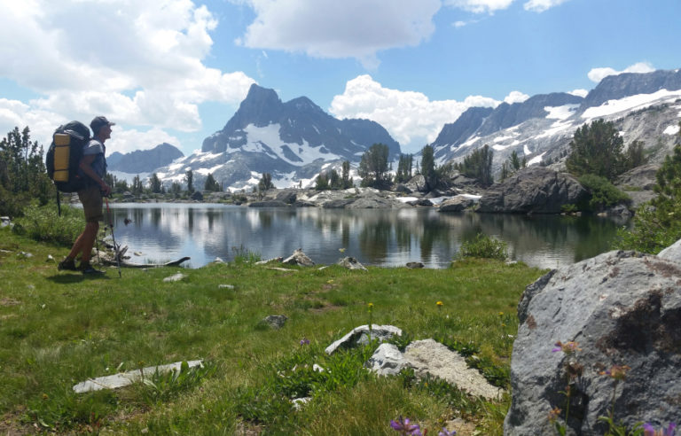 Dave Deal stands in front of an alpine lake in the Sierra Nevada Mountains last summer, with Banner Peak in the distance.