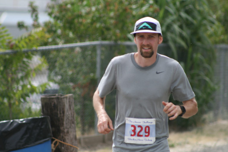 Casey Kemp runs along the Columbia River Dike Trail on his way to winning The Heroes' Challenge 10K.