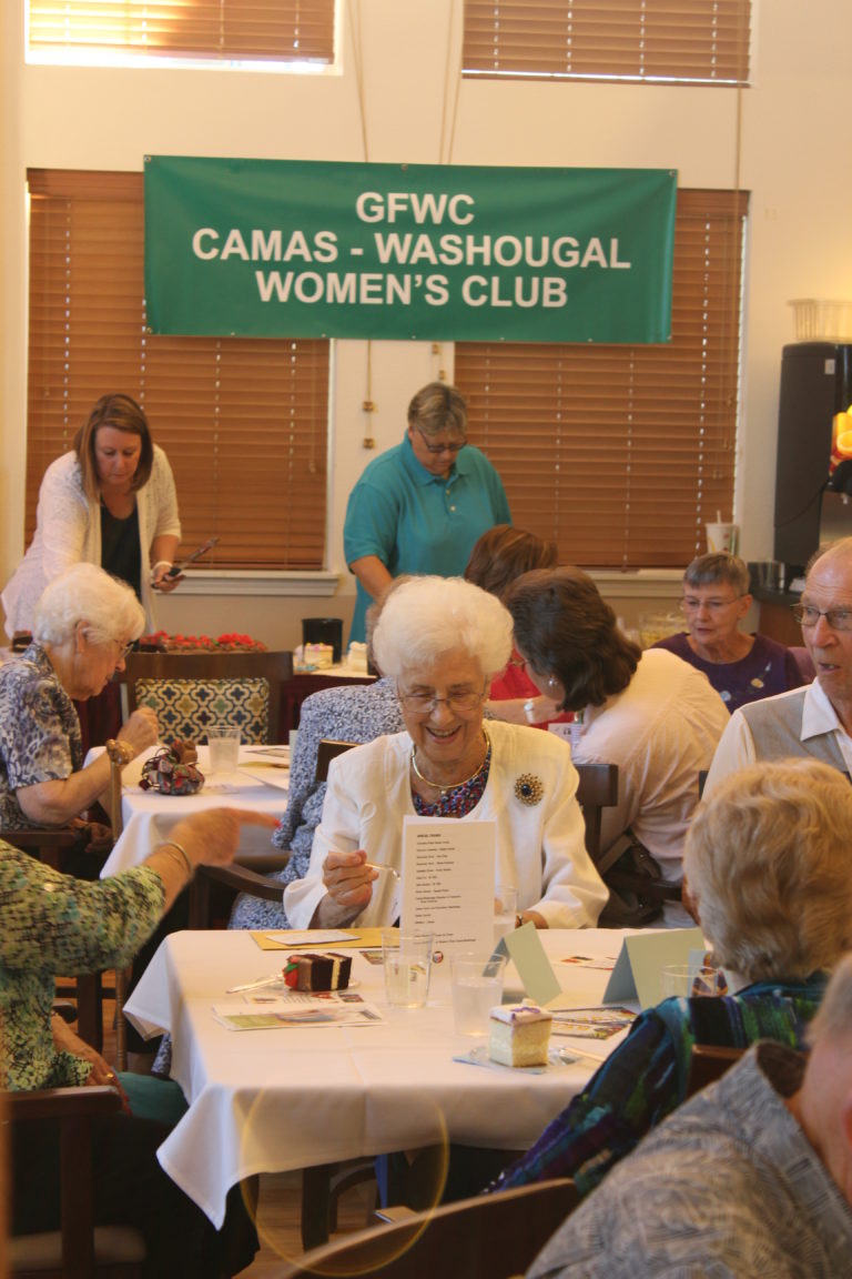 2018 Camas Days Queen Maxine Ambrose (center, wearing white) enjoys her coronation reception July 18, at the Columbia Ridge Senior Living center in Washougal.